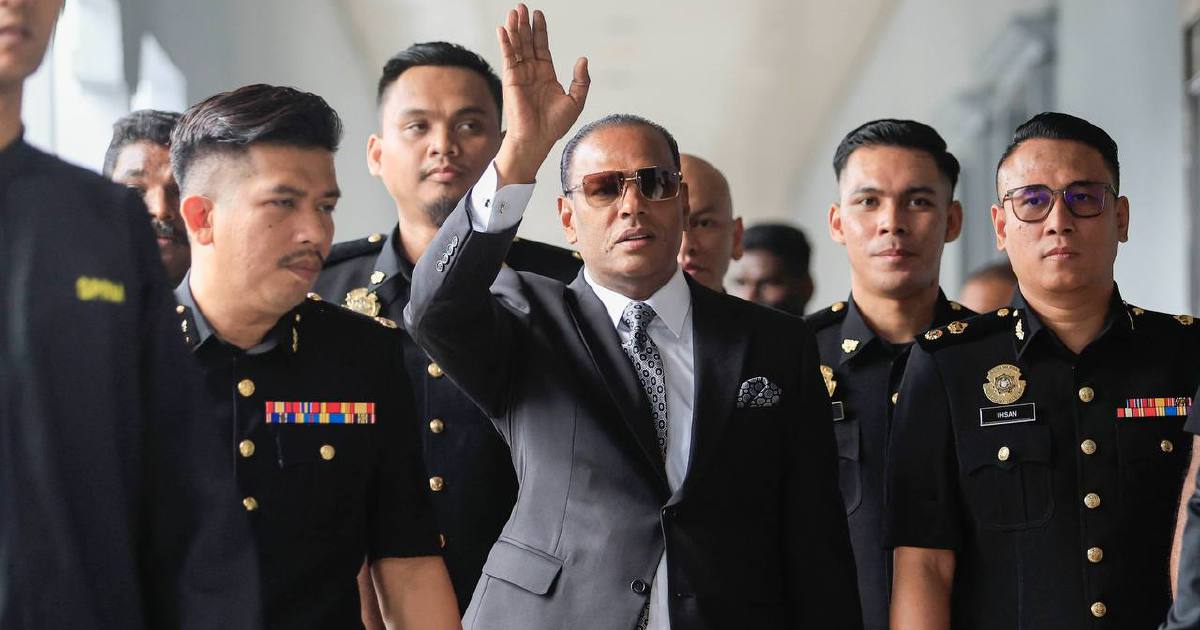 Saravanan greets cheering supporters as he arrives for court hearing on labour recruitment charges