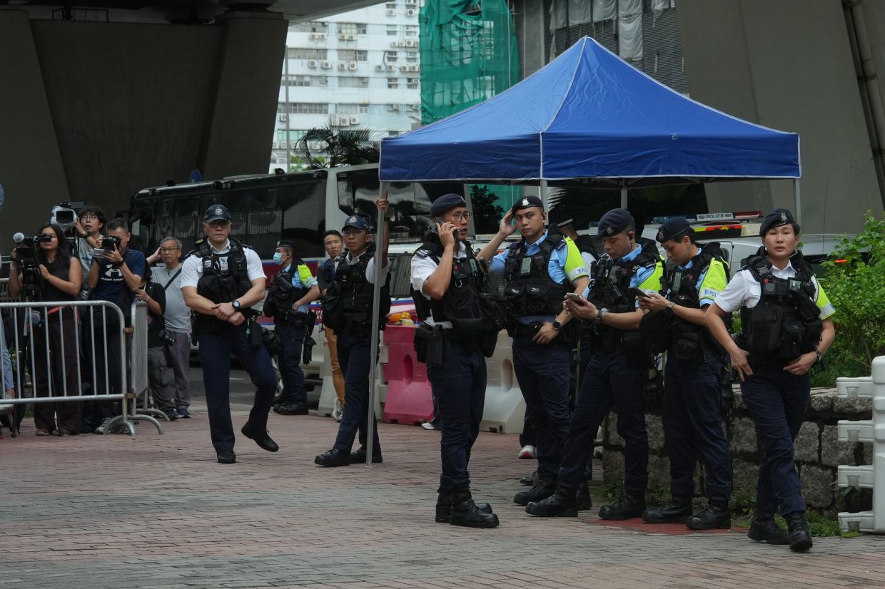 Hong Kong Woman Arrested for Seditious T-Shirt Outside Court as Landmark Subversion Trial Concludes
